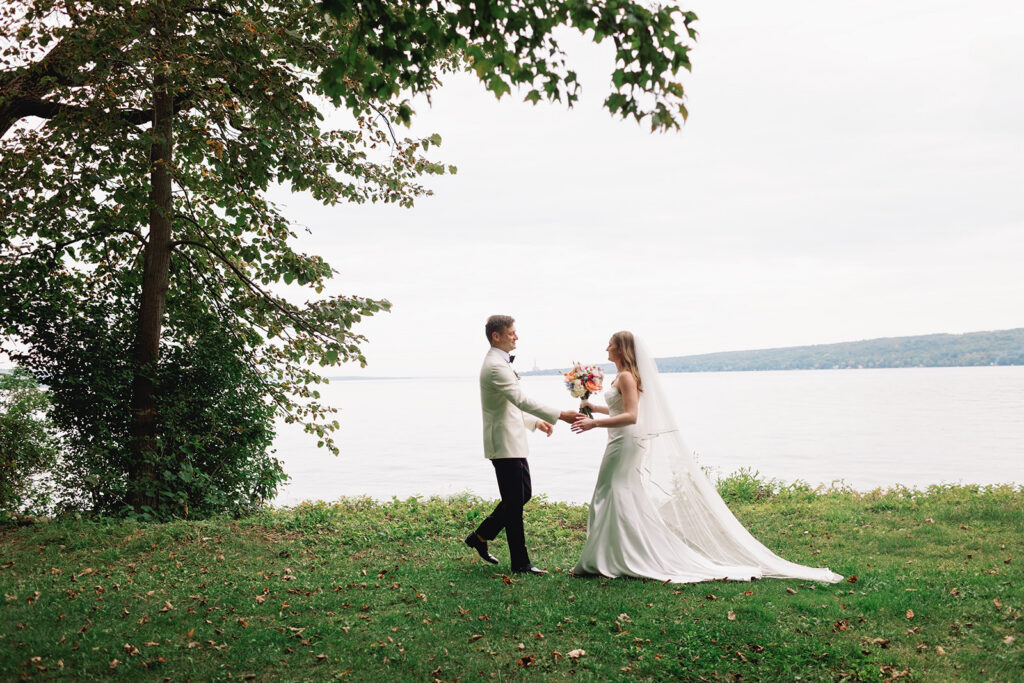 Bride and groom on the shore of Cayuga Lake at Inn at Taughannock Falls