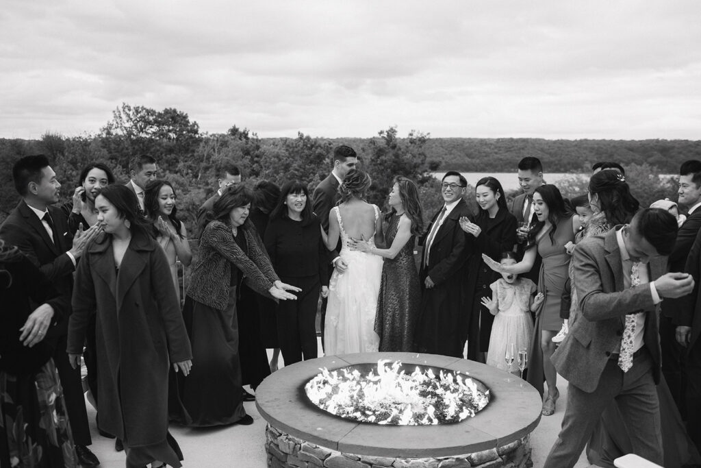 Wedding guests laughing during outdoor cocktail hour Inn at Taughannock Falls
